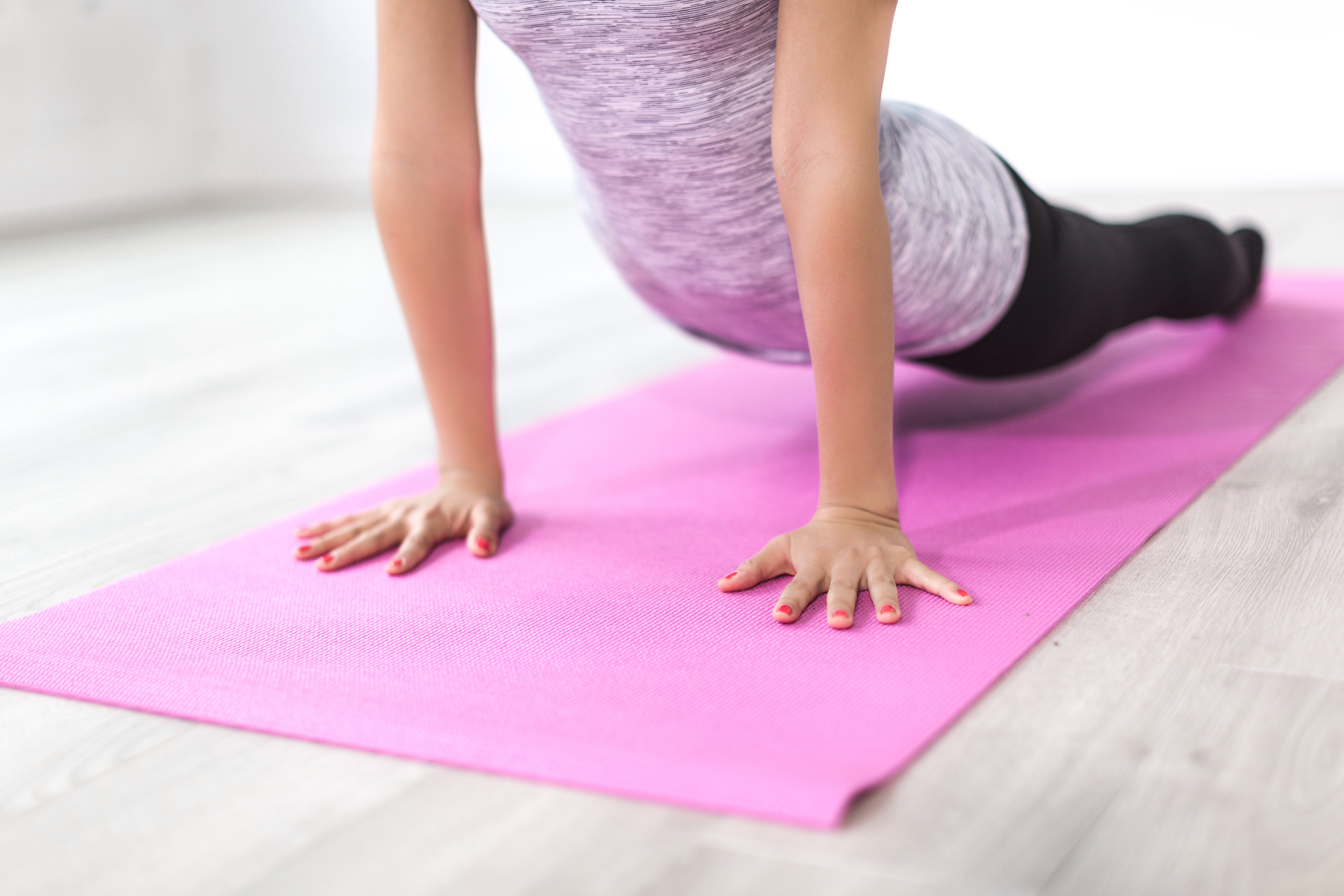 Image of a girl exercising on a yoga mat.