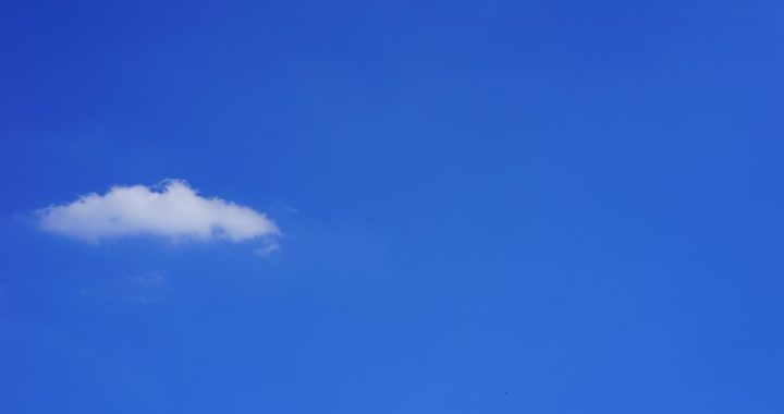Image of a single cloud in a vast blue sky.